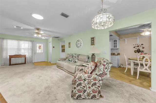a living room with furniture and a chandelier
