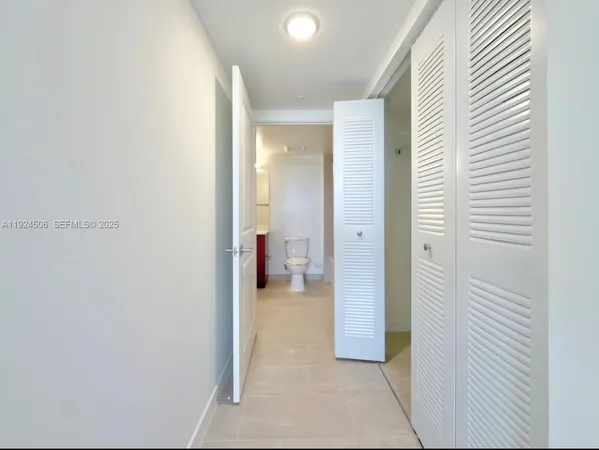 a view of a hallway with a bathroom