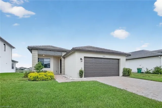a front view of house with yard and green space