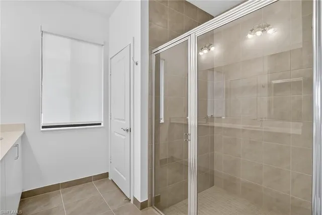 a bathroom with a shower and a glass door