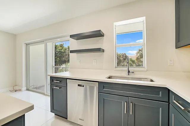 a kitchen with a sink and a window
