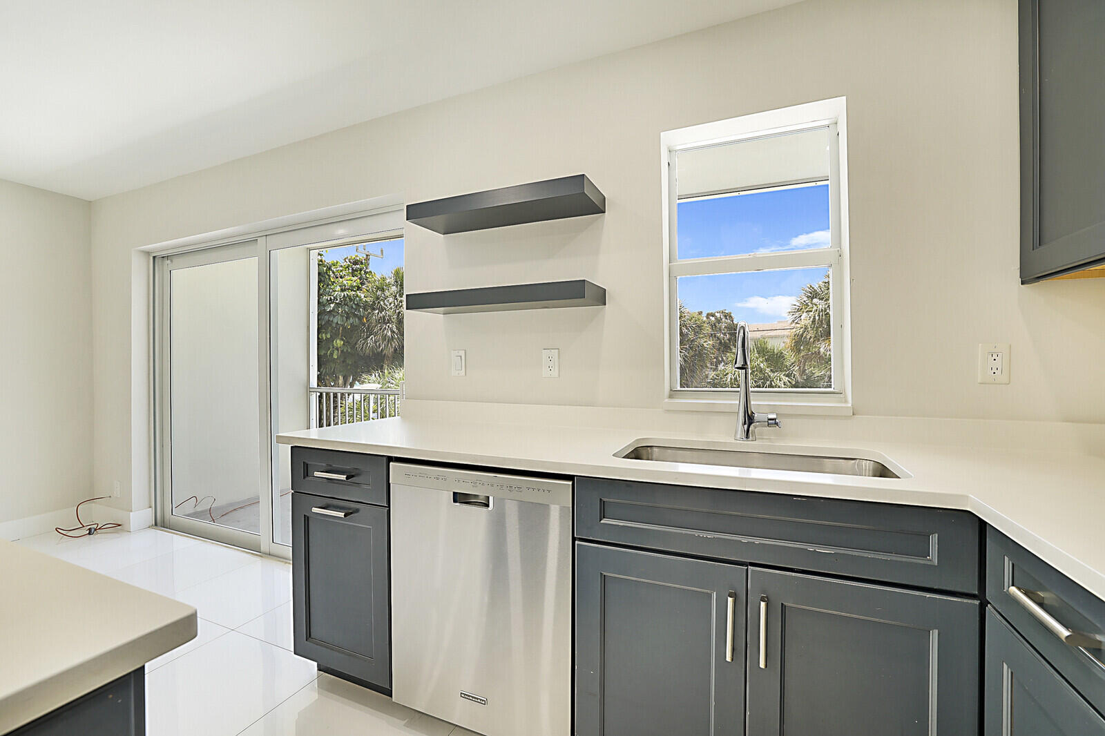 1439 South Ocean Boulevard, Unit 208 Lauderdale-by-the-Sea, FL 33062 - Photo 11 of 27 a kitchen with a sink and a window