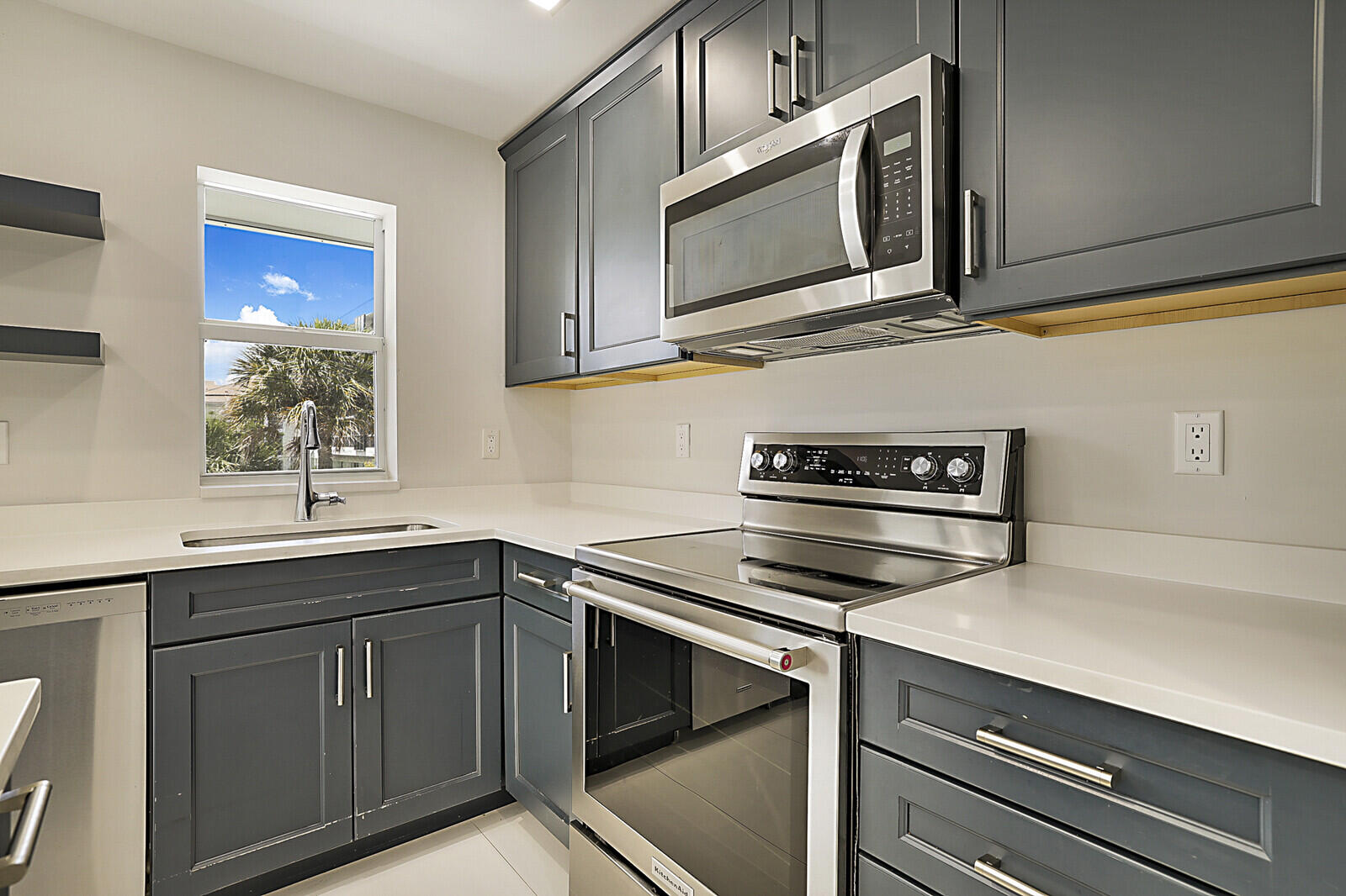 1439 South Ocean Boulevard, Unit 208 Lauderdale-by-the-Sea, FL 33062 - Photo 12 of 27 a kitchen with stainless steel appliances granite countertop a sink and cabinets