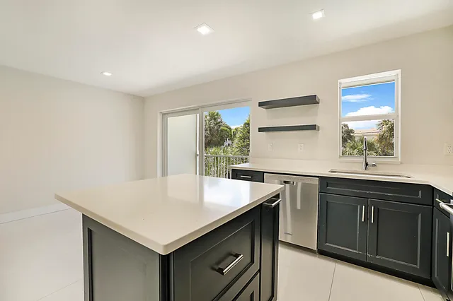 a kitchen with a sink cabinets and window