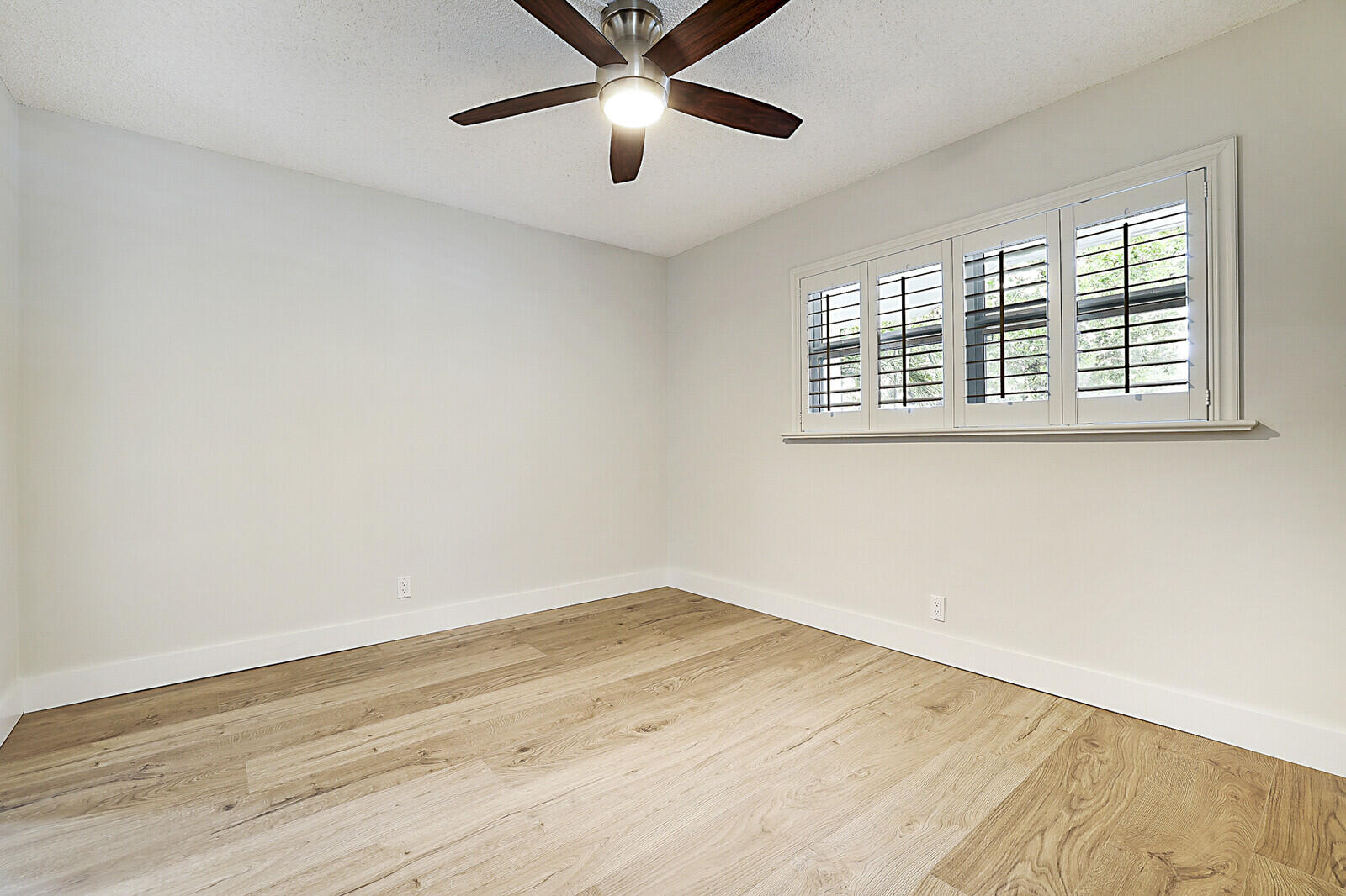 1439 South Ocean Boulevard, Unit 208 Lauderdale-by-the-Sea, FL 33062 - Photo 15 of 27 a view of an empty room with wooden floor and a window