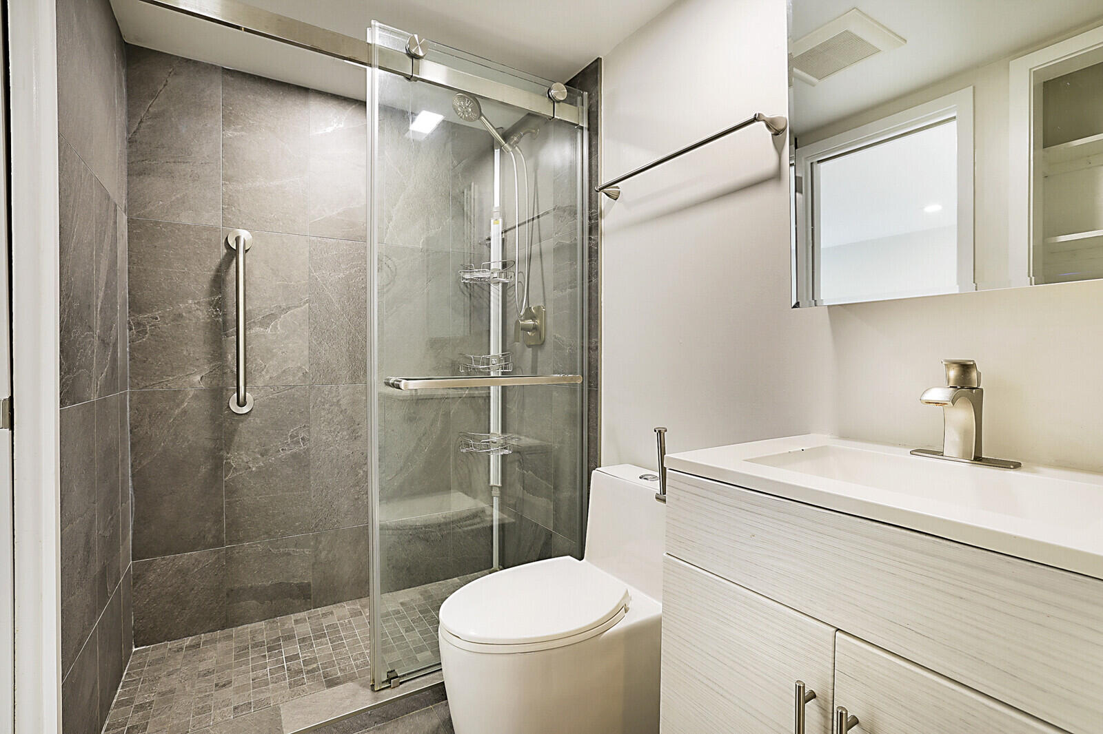 1439 South Ocean Boulevard, Unit 208 Lauderdale-by-the-Sea, FL 33062 - Photo 19 of 27 a bathroom with a sink toilet and shower