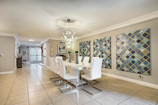 a view of a dining room with furniture and chandelier