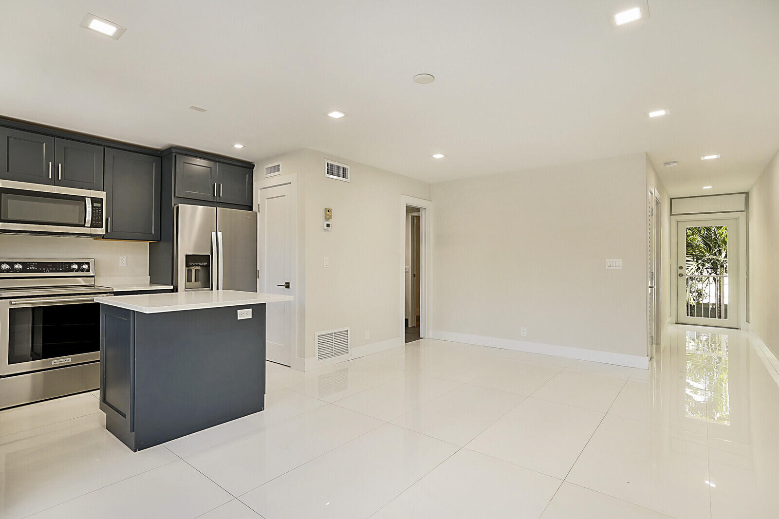1439 South Ocean Boulevard, Unit 208 Lauderdale-by-the-Sea, FL 33062 - Photo 5 of 27 a kitchen with stainless steel appliances a refrigerator and a stove top oven