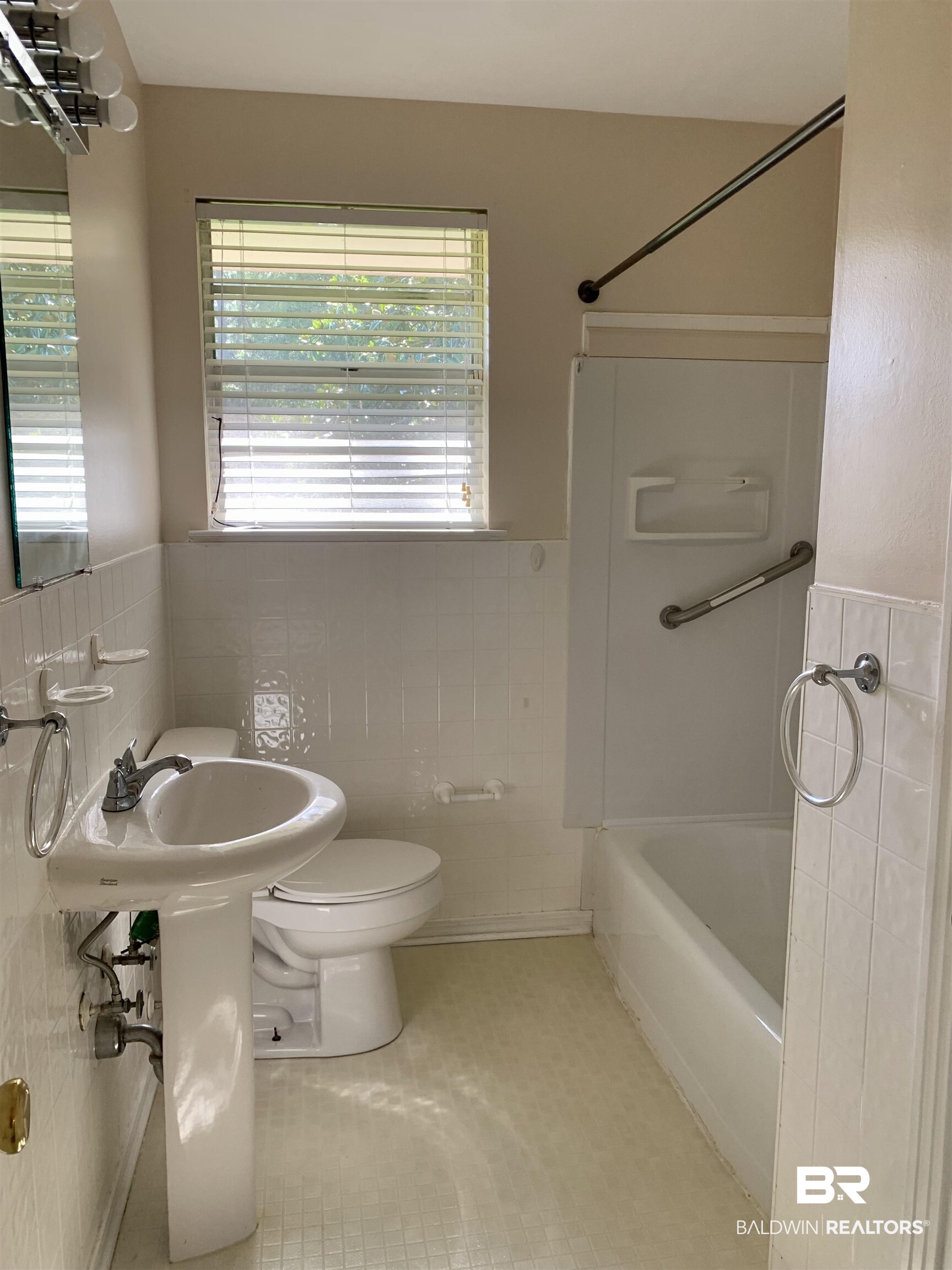 2710 West Road Mobile, AL 36693 - Photo 8 of 10 Bathroom with shower / tub combination, toilet, tile walls, tile patterned floors, and decorative backsplash