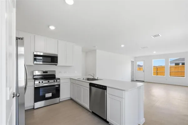 a kitchen with a sink stainless steel appliances and cabinets