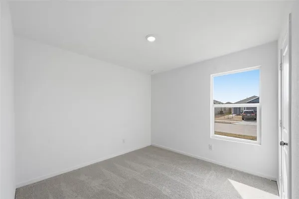 a view of an empty room and a window