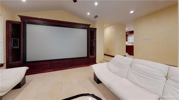 a bedroom with a bed and a large mirror