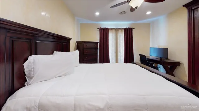 a bedroom with a bed and a television