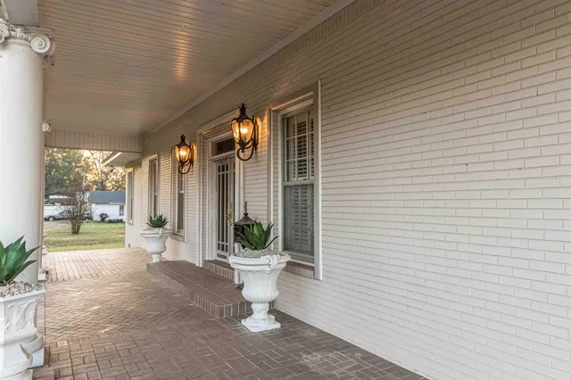 a view of a patio with table and chairs and potted plants