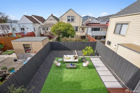 a view of a dining room with a table and chairs