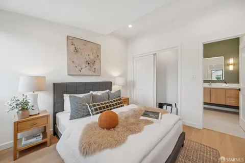 a view of a street sign under a large tree