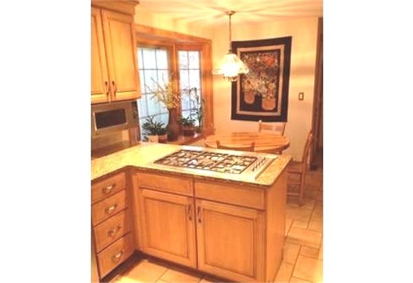 122 Worthen Road Lexington, MA 02421 - Photo 3 of 6 a kitchen with stainless steel appliances granite countertop a stove and a refrigerator