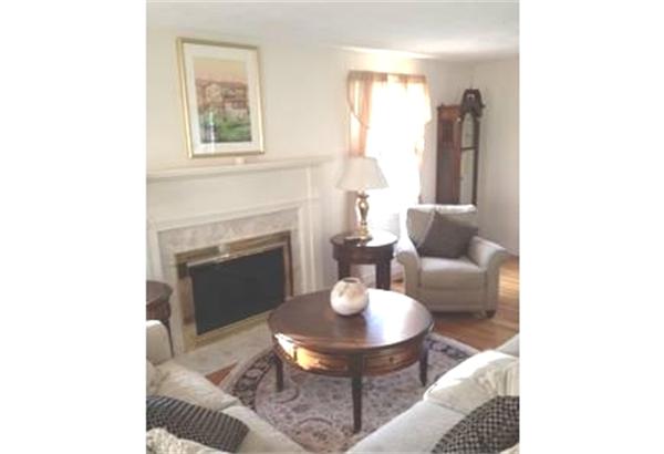 122 Worthen Road Lexington, MA 02421 - Photo 4 of 6 a living room with furniture and a fireplace