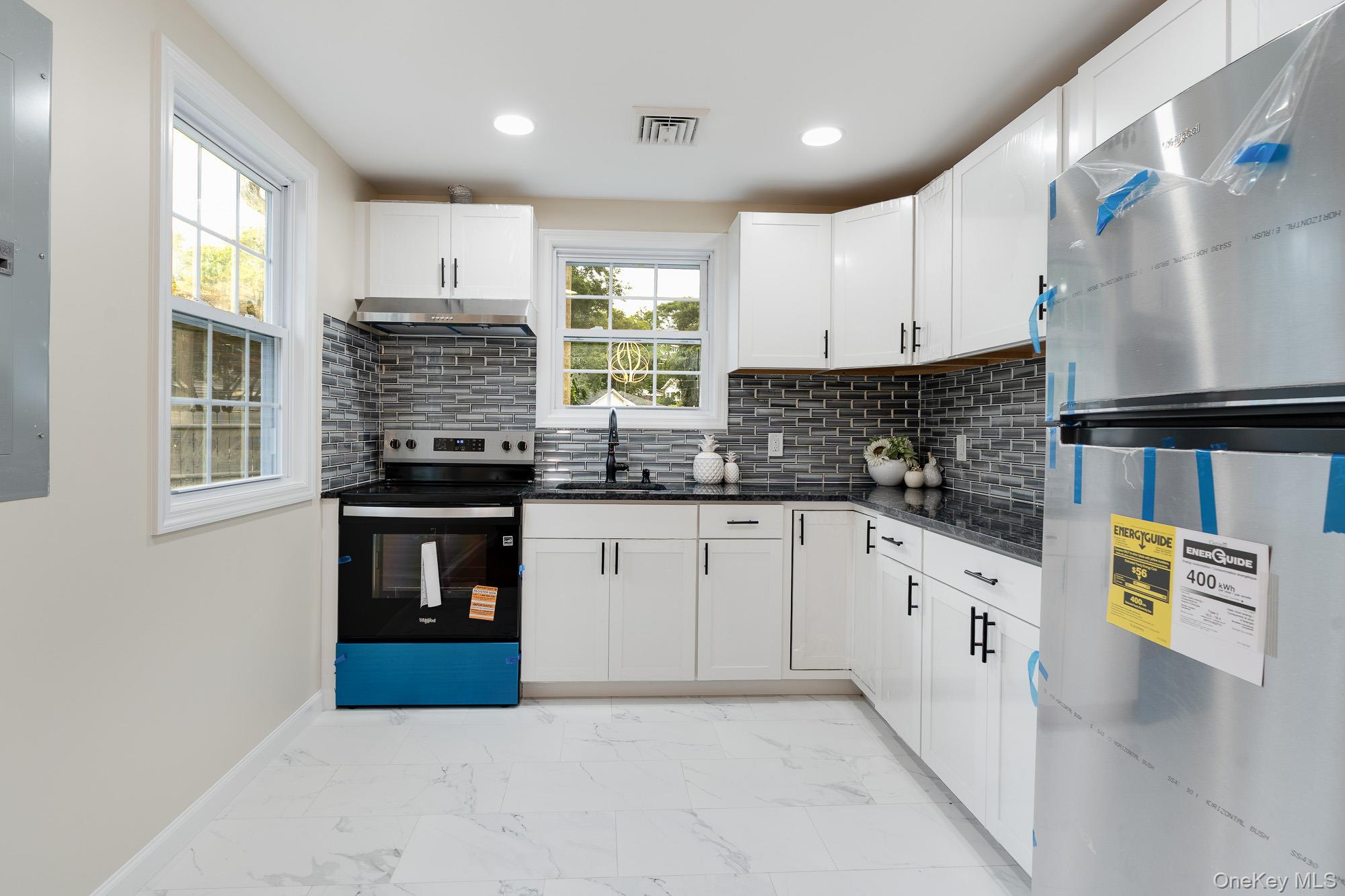 3167 Lincoln Drive Mohegan Lake, NY 10547 - Photo 12 of 34 a kitchen with stainless steel appliances granite countertop a refrigerator sink and cabinets