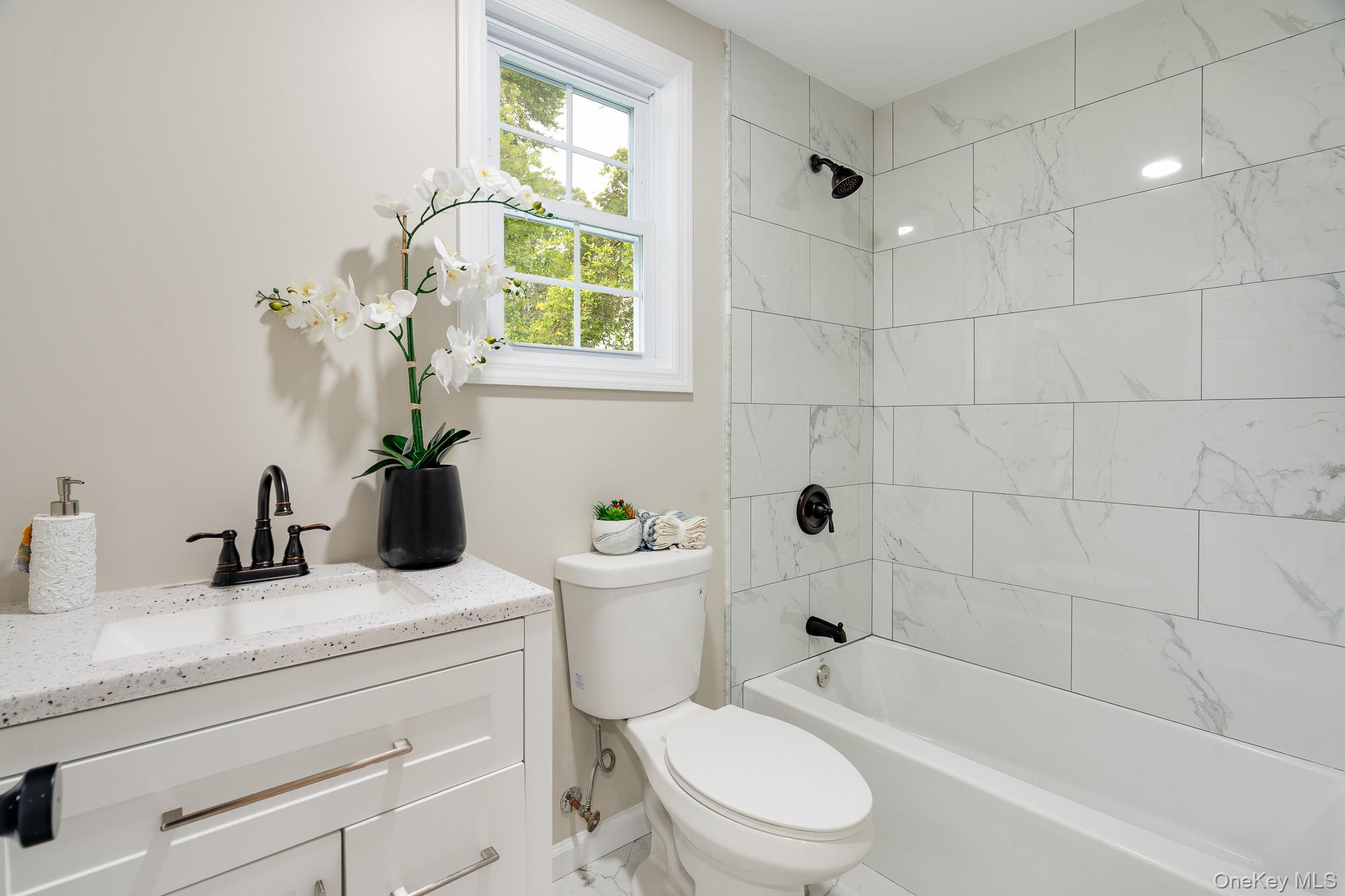 3167 Lincoln Drive Mohegan Lake, NY 10547 - Photo 16 of 34 a bathroom with a sink a toilet and bathtub