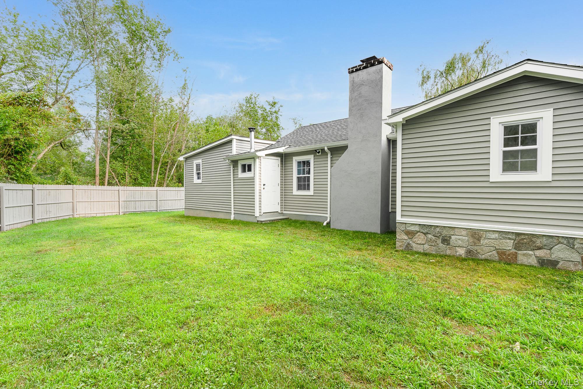 3167 Lincoln Drive Mohegan Lake, NY 10547 - Photo 26 of 34 a view of a house with a yard and plants