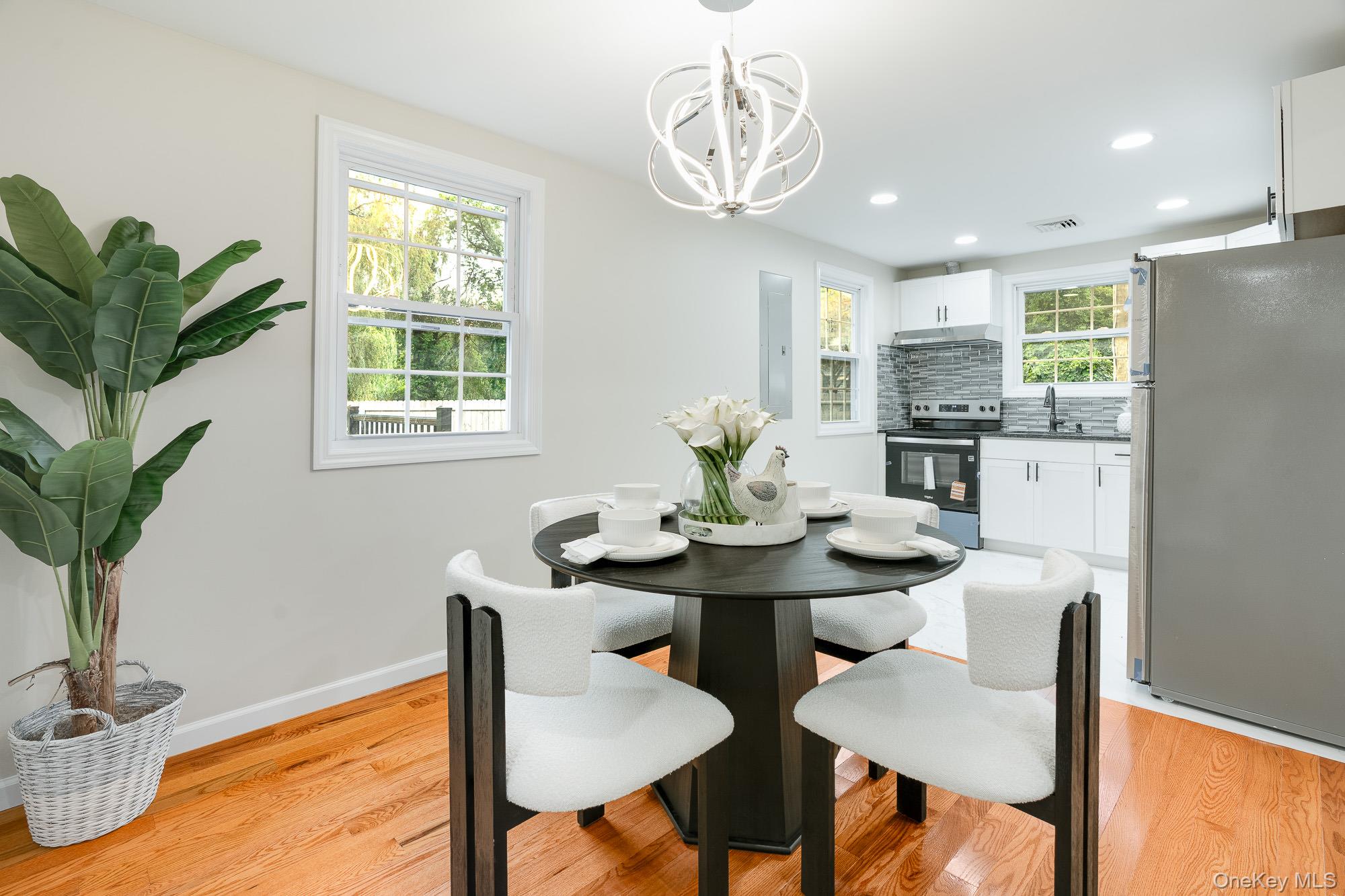 3167 Lincoln Drive Mohegan Lake, NY 10547 - Photo 8 of 34 a view of a dining room with furniture and a potted plant
