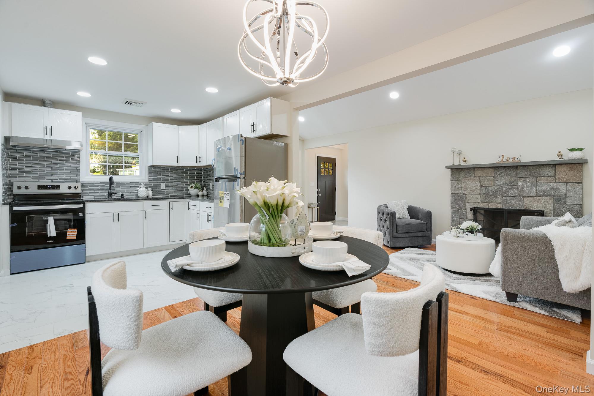 3167 Lincoln Drive Mohegan Lake, NY 10547 - Photo 9 of 34 a kitchen with a dining table and chairs