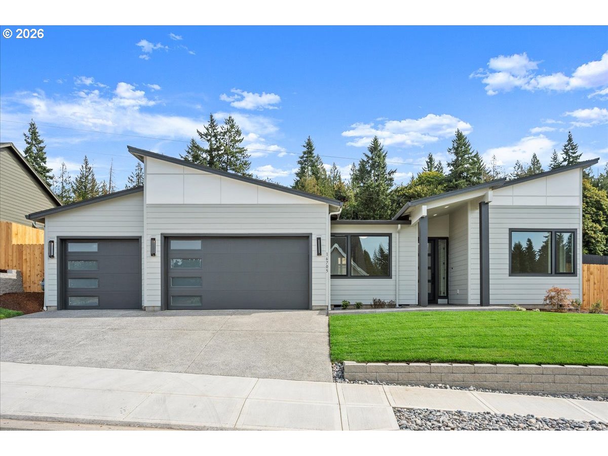 16705 Northeast 38th Avenue Vancouver, WA 98686 - Photo 1 of 45 a front view of a house with a yard and garage