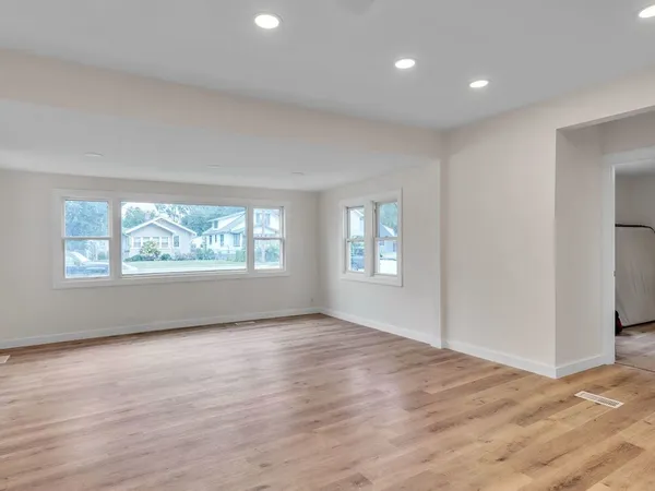a view of a room with wooden floor