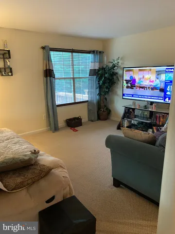 a bedroom with furniture and a flat screen tv