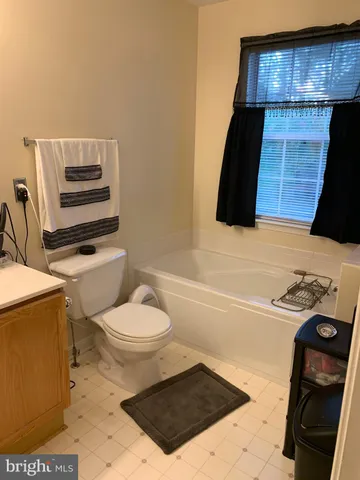 a bathroom with a toilet a sink and bathtub