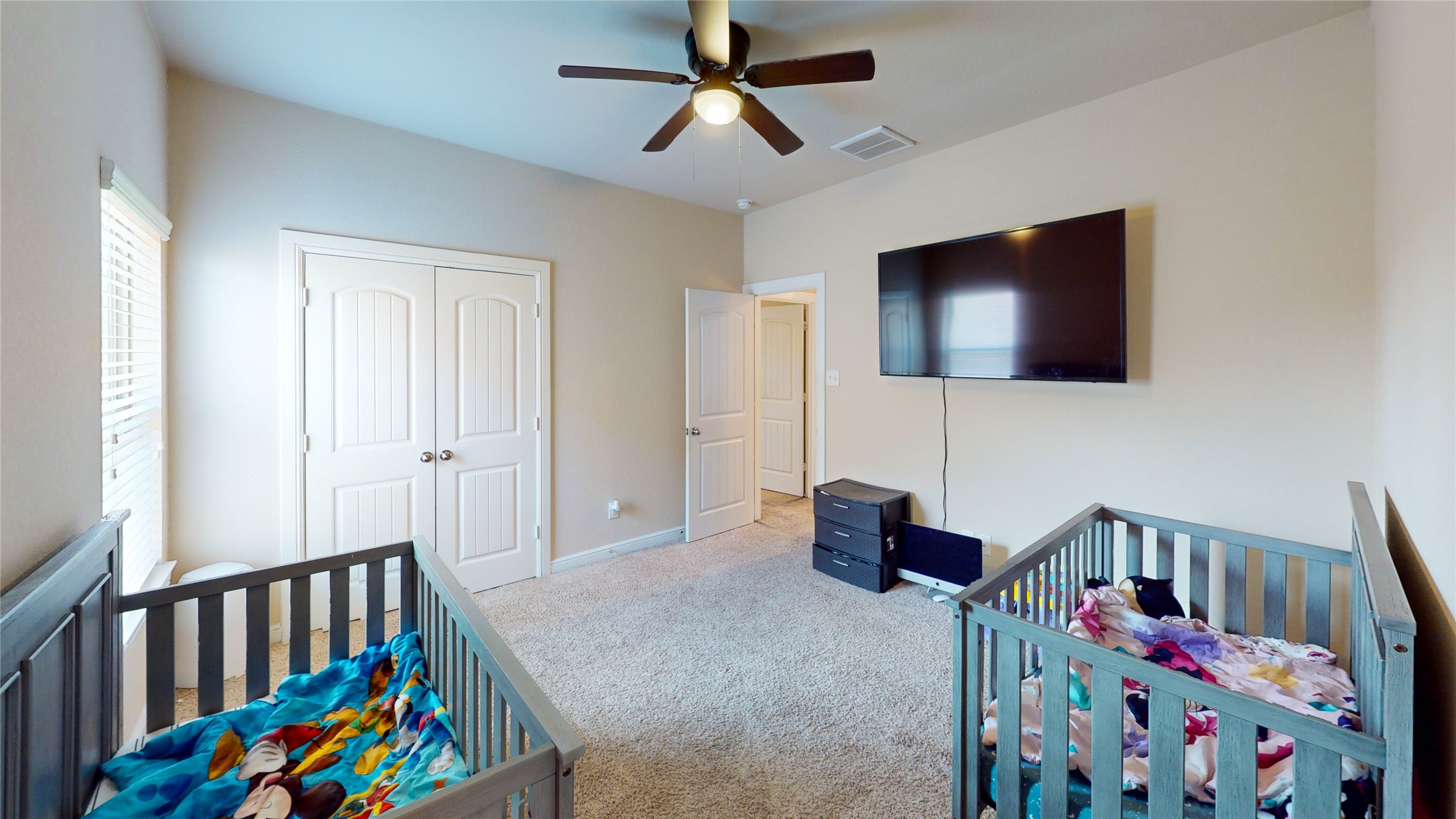 14535 Julie Meadows Lane Humble, TX 77396 - Photo 21 of 35 a living room with baby crib furniture and a flat screen tv