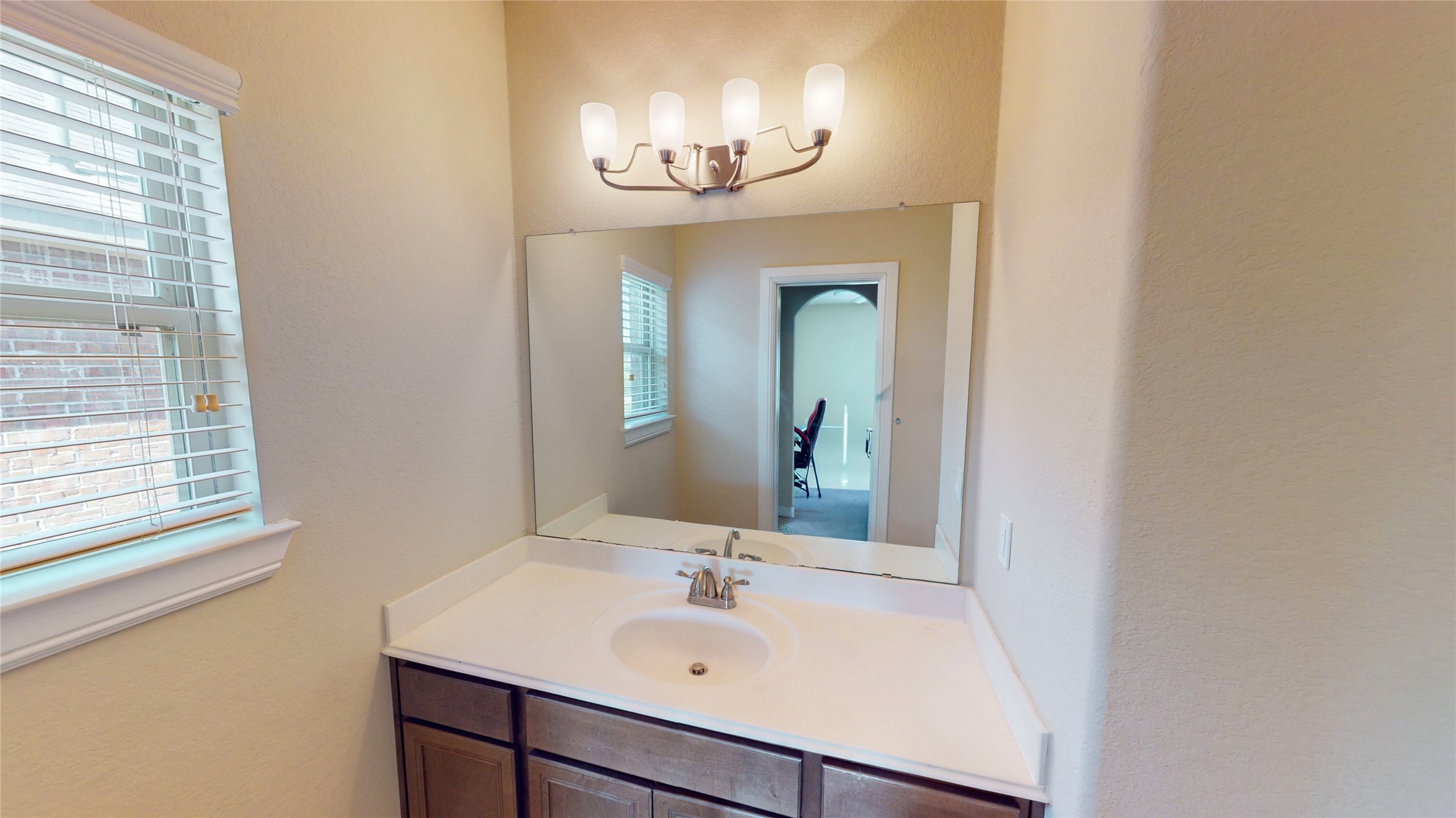 14535 Julie Meadows Lane Humble, TX 77396 - Photo 27 of 35 a bathroom with a sink and a mirror