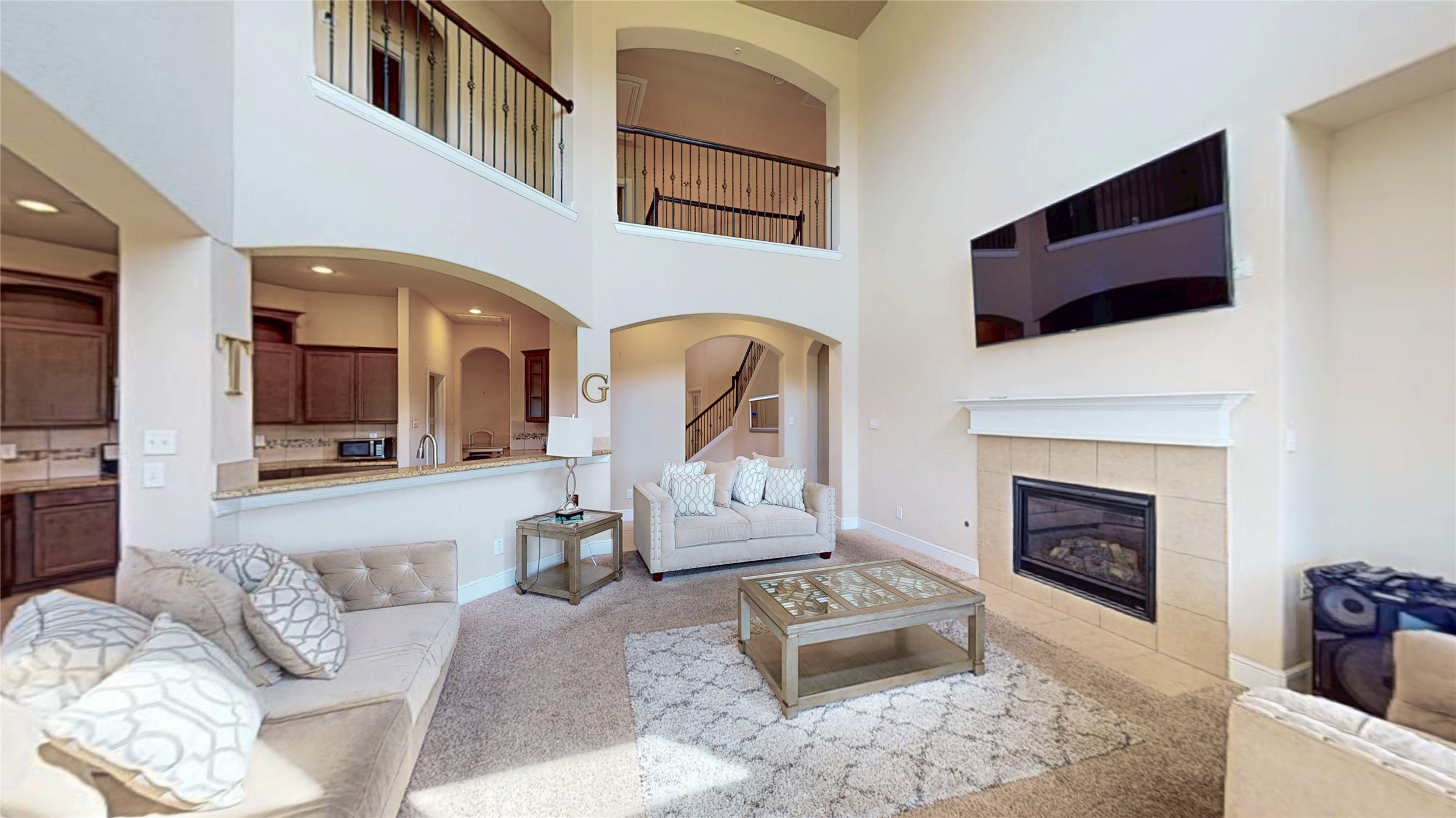 14535 Julie Meadows Lane Humble, TX 77396 - Photo 7 of 35 a living room with furniture a fireplace and a flat screen tv