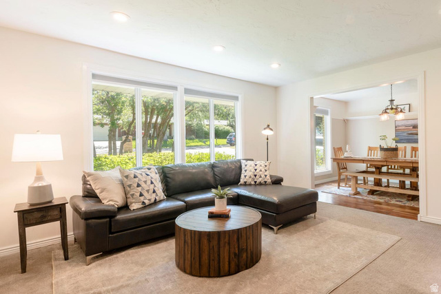9676 Mt Jordan Road Sandy, UT 84092 - Photo 6 of 38 Bright living area with recessed lighting, large windows, an open doorway, and carpet flooring