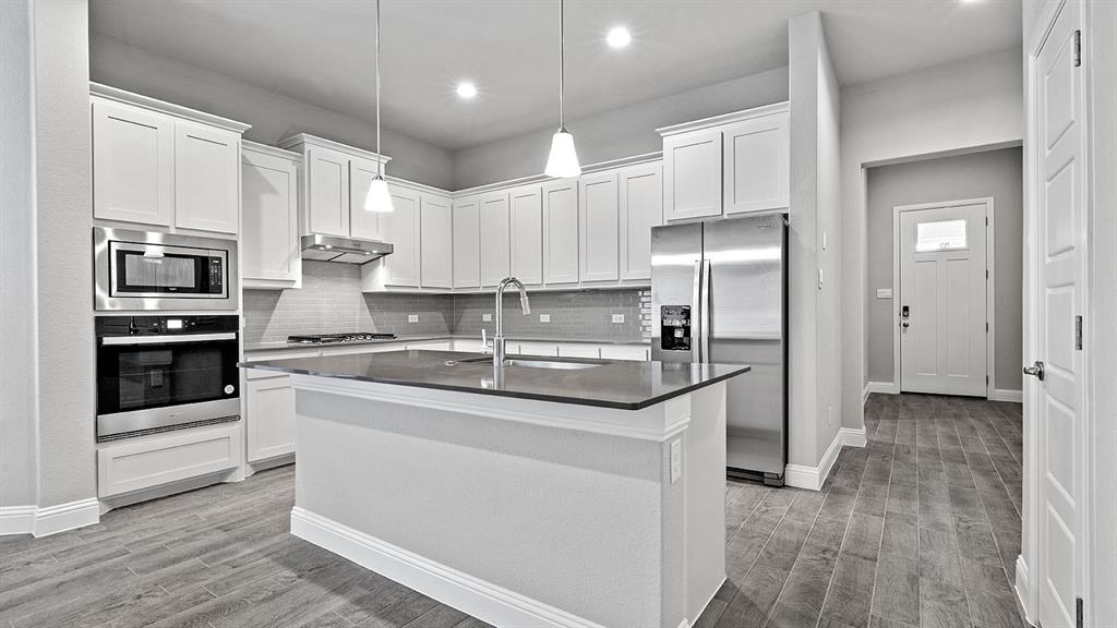 2513 Starling Street Denton, TX 76205 - Photo 38 of 40 Kitchen- MLS Photos:All Home and community information, including pricing, included features, terms, availability and amenities, are subject to change at any time without notice or obligation. All Drawings, pictures, photographs, video, square footages, floor plans, elevations, features, colors and sizes are approximate for illustration purposes only and will vary from the homes as built.