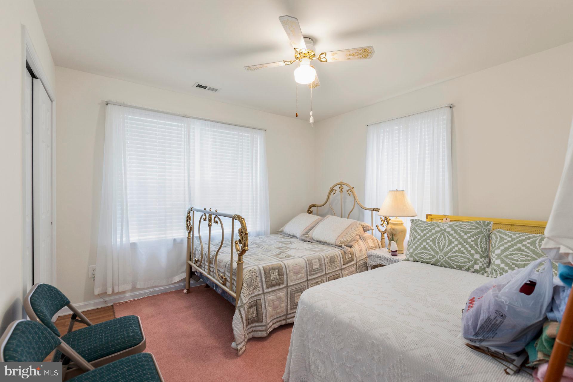 49898 Airedele Road Ridge, MD 20680 - Photo 22 of 30 a bedroom with two beds and a chandelier