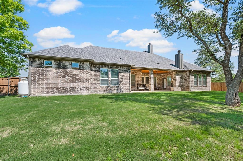 200 Clayton Crossing Springtown, TX 76082 - Photo 36 of 40 a front view of a house with a garden