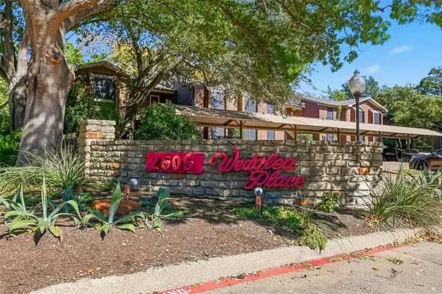 a front view of a house with sign board