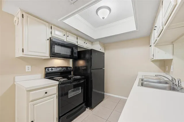 a kitchen with stainless steel appliances a stove a microwave and cabinets