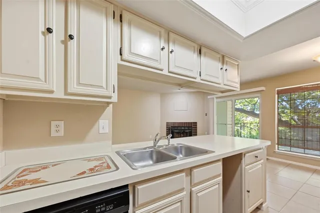 a kitchen with granite countertop a sink and cabinets