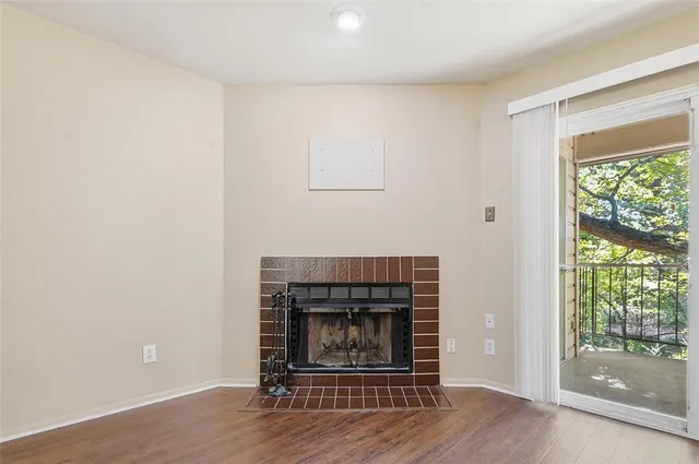 a living room with a fireplace and a floor to ceiling window