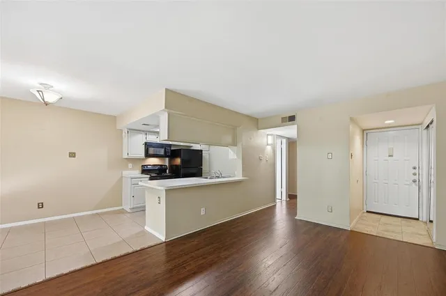 a kitchen with granite countertop a stove and a refrigerator