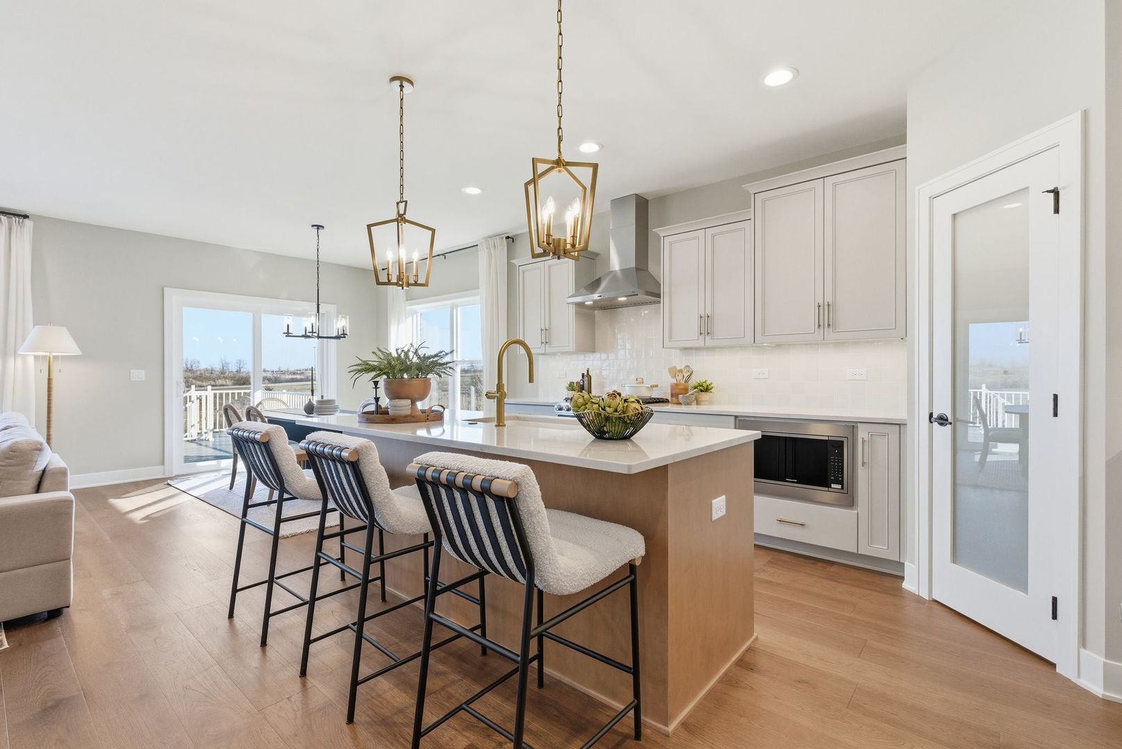 16541 Kayla Drive Lemont, IL 60439 - Photo 13 of 33 a view of a dining room and livingroom with furniture wooden floor kitchen chandelier and a view of kitchen