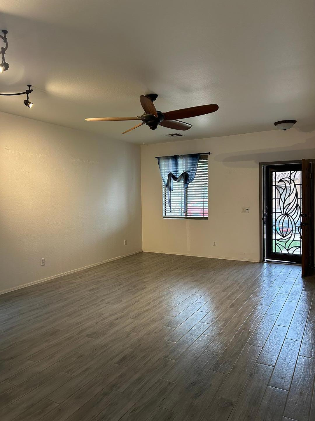 7044 West Alta Vista Road Laveen, AZ 85339 - Photo 2 of 11 an empty room with wooden floor and windows