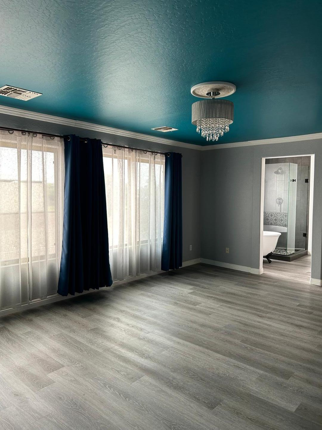 7044 West Alta Vista Road Laveen, AZ 85339 - Photo 6 of 11 an empty room with wooden floor and windows