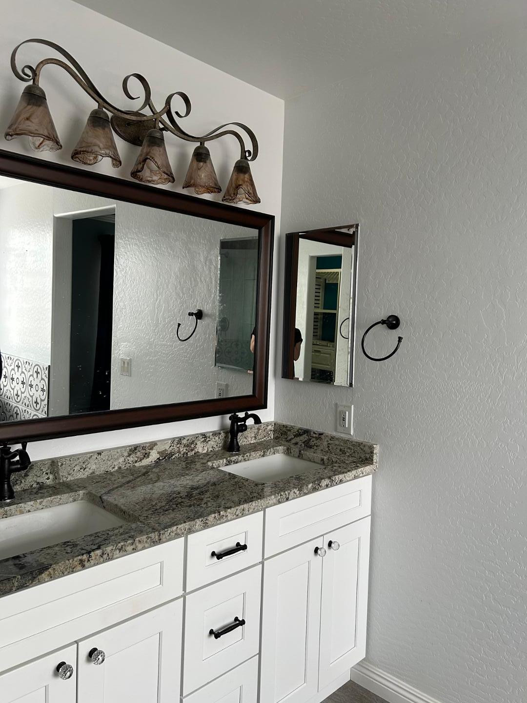 7044 West Alta Vista Road Laveen, AZ 85339 - Photo 8 of 11 a bathroom with a granite countertop sink and a mirror