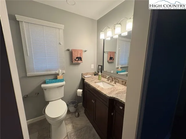 a white toilet sitting next to a bathroom sink