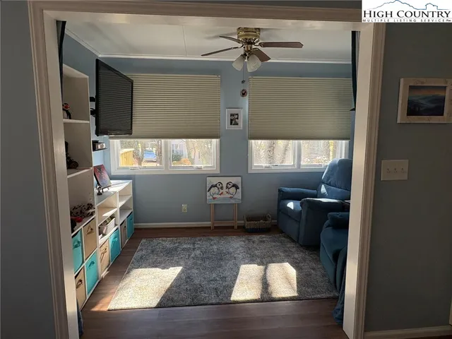 a room with furniture a flat screen tv and a window