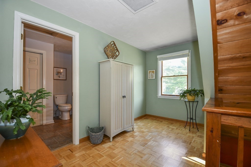 60 Peabody Road, Unit B Shirley, MA 01464 - Photo 13 of 42 a view of a hallway with wooden cabinet and a potted plant